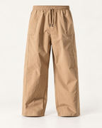 Relaxed wide-leg trousers in Stone — studio view
